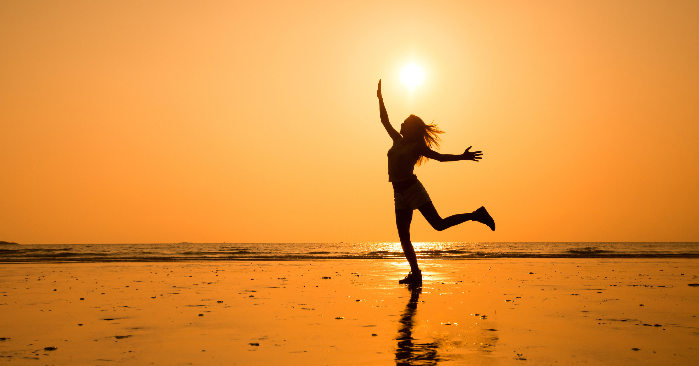 A girl walking freely in the evening sun near the ocean